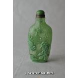 A Chinese green glass snuff bottle moulded with heron, birds and lotus flower.