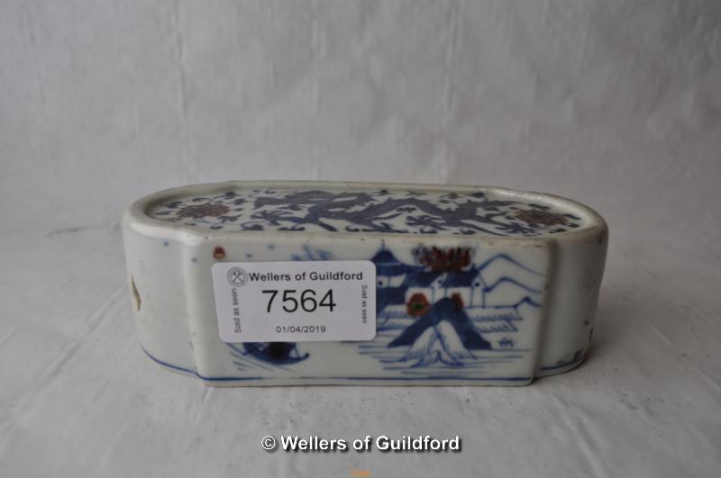 A Chinese blue and white paperweight decorated with a dragon, 13cm long.