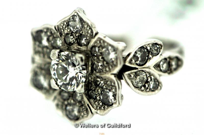 18ct white gold diamond ring, central round brilliant cut diamond surrounded by diamond melee's