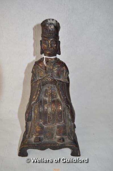 A Chinese cast iron figure of Taoist the immortal, traces of gilt paint, 23cm.