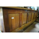 LARGE MAHOGANY SHOP COUNTER WITH PANELLED FRONT AND OPEN SHELVING BEHIND, 327CM WIDE