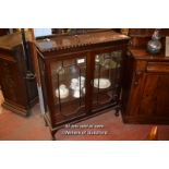 1920S MAHOGANY DISPLAY CABINET WITH TWO GLAZED DOORS ENCLOSING SHELVES RAISED ON CABRIOLE LEGS,