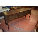 PERIOD OAK DRESSER BASE WITH THREE CARVED DRAWERS AND LARGE BRASS HANDLES, RAISED ON CABRIOLE