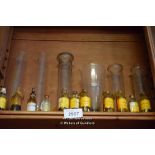 SHELF OF CHEMIST JARS AND TEST TUBES