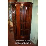 PAIR OF MAHOGANY HALF MOON DISPLAY CABINETS WITH BEVELLED GLASS DOORS ENCLOSING GLASS SHELVES,