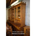 LARGE AND IMPOSING OAK CABINET WITH CENTRAL SHELVES FLANKED BY GLAZED DOORS, THE BASE WITH SIX SHORT