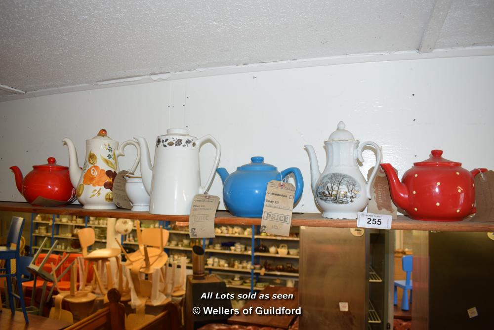 *SHELF OF MIXED PORCELAIN WARES, MAINLY TEA/COFFEE POTS