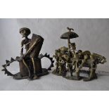 A naive African bronze figure group of a group of men carrying a chieftain, separate wooden stand,