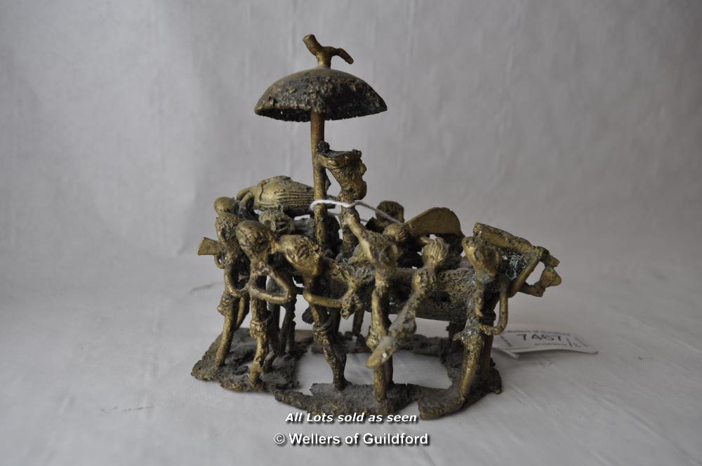 A naive African bronze figure group of a group of men carrying a chieftain, separate wooden stand, - Image 5 of 6