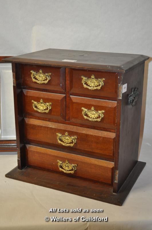 An Edwardian mahogany collector's cabinet with two glazed doors enclosing four short over two long