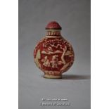 A Chinese relief moulded snuff bottle