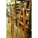 *Two vintage cylindrical mahogany tripods with brass mounts.