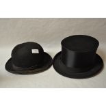 A vintage large sized satin theatrical top hat by Trademark with vintage bowler hat