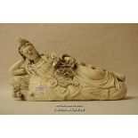 A Chinese blanc-de-chine figure of a goddess lying on a base of lotus flowers, 38cm