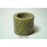 Chinese green jade archer's thumb ring with carved decoration.