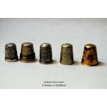 Two silver thimbles and three others.