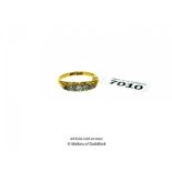 Diamond five stone ring, five graduated diamonds mounted in an openwork scroll design, set in yellow