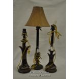 A tall cast metal table lamp with faux antler decoration; a similar graduated pair.