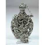 A Chinese white metal pierced scent bottle decorated with figures in a garden, impressed character