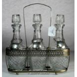 A silver plated decanter holder with three glass bottles, each with silver plated decanter label.