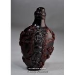 A large Chinese snuff bottle carved with Buddha and children, 12cm.