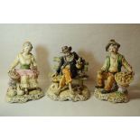 Three Capi di Monte figures^ one of a tramp on a bench^ the others a pair of market traders. (3)