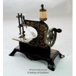 German painted metal miniature sewing machine, 16.5cm wide.