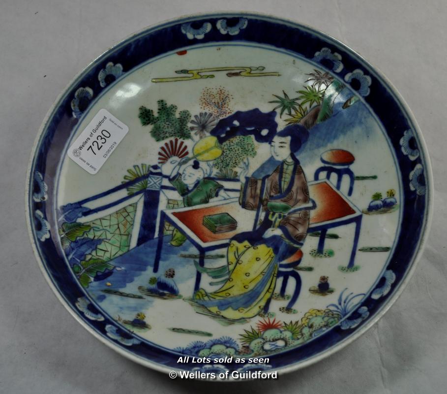 Chinese polychrome dish decorated with a lady seated in a garden, two blue rings to base, 22cm