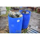 TWO PLASTIC DRUMS FULL OF COBBLE SETTS