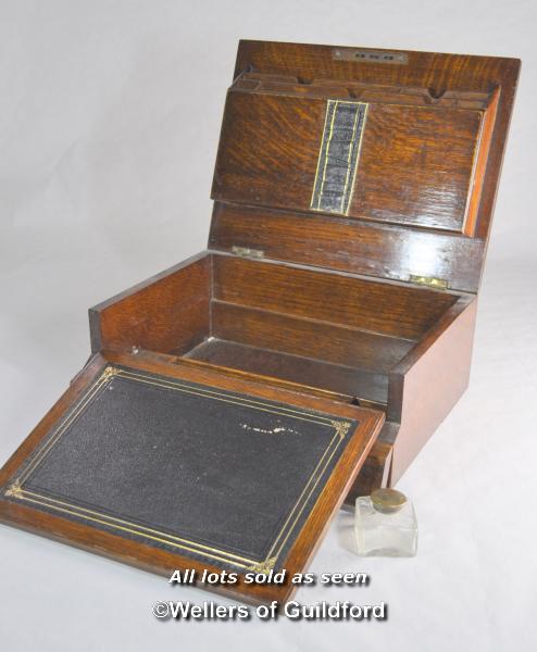 An Edwardian oak lap desk with inset brass handle monogrammed GWB and dated Jan 27 1904, the lifting