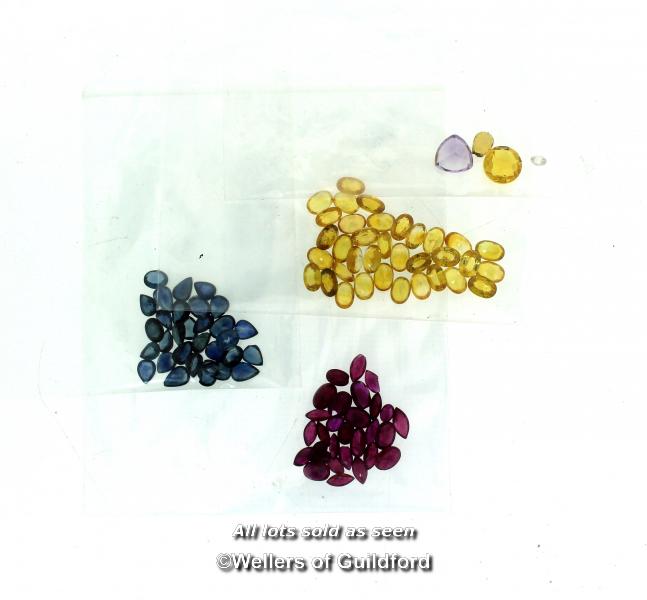 Quantity of loose gemstones, including yellow sapphires, blue sapphires and rubies