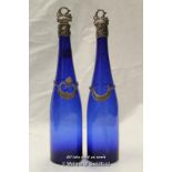 A pair of blue glass bottles with silver mounts and silver wine decanter labels, 'Tenerife' and '