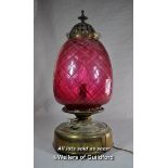 Cranberry glass pineapple lamp with brass mounts, fitted for electricity, 55cm.