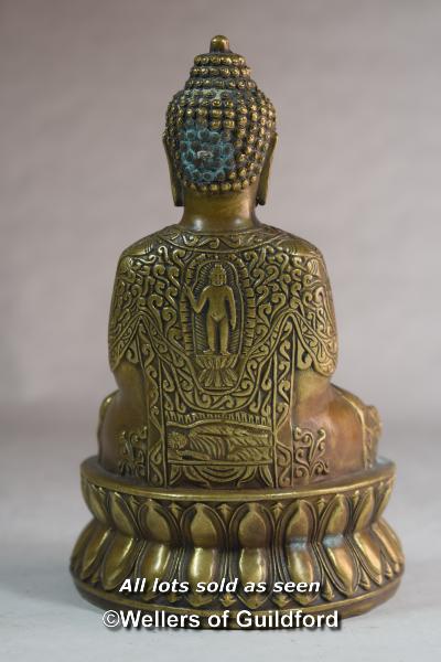 A Chinese bronze figure of a buddha seated on a lotus flower, 17cm. - Image 2 of 3