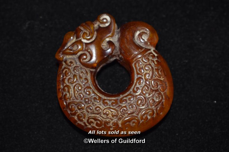 A Chinese amber pendant carved as a dragon. - Image 2 of 2