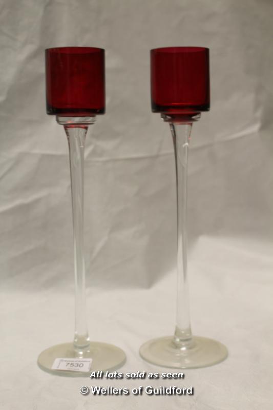 A pair of tall glass candle sticks