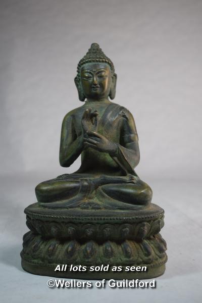 A Chinese bronzed figure of seated buddha, 21cm.