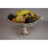 A collection of carved stone fruits and nuts, including almonds, walnuts, figs, bananas and oranges,