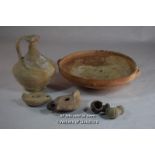 Roman pottery comprising a bowl, 23cm diameter, a jug, 15cm, two oil lamps, two pipes (6).