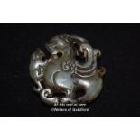 A Chinese hardstone pendant carved ass a dragon.