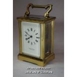A brass carriage clock with white enamel dial marked Garrard & Co Ltd.