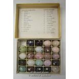 A set of 24 (out of 25) small polished specimen gemstone eggs, boxed.