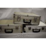 Three metal photographic equipment cases
