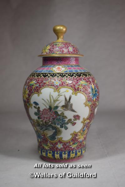 A Chinese polychrome vase and cover, with reserve panels decorated birds and prunus, 21cm.