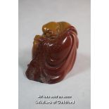 A Chinese hardstone paperweight carved as a buddha.