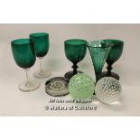 Two pairs of green glass drinking glasses, a similar single example; three paperweights.(8)