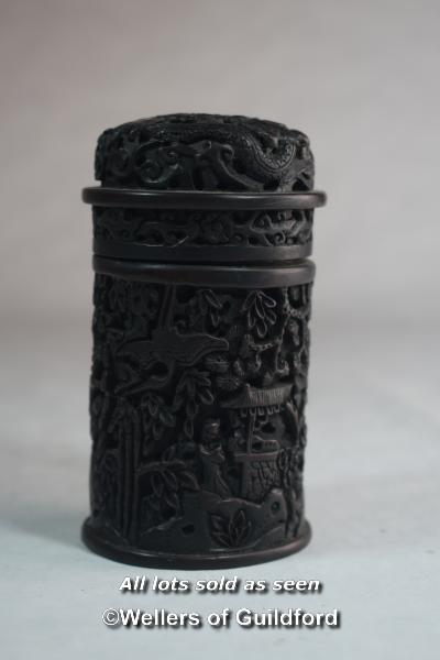 A Chinese carved cylindrical pot and cover with all over carved decoration.