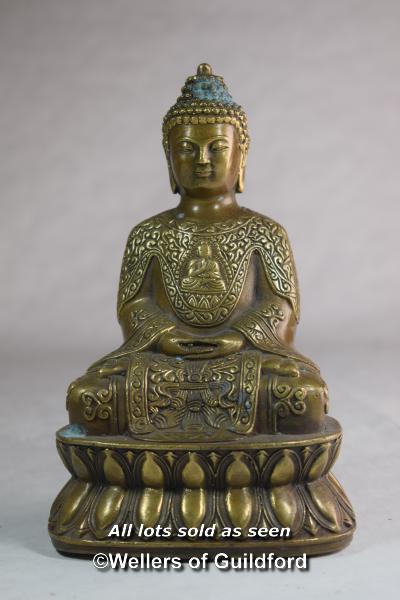 A Chinese bronze figure of a buddha seated on a lotus flower, 17cm.