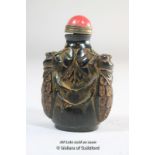 A Chinese horn snuff bottle carved with bees.