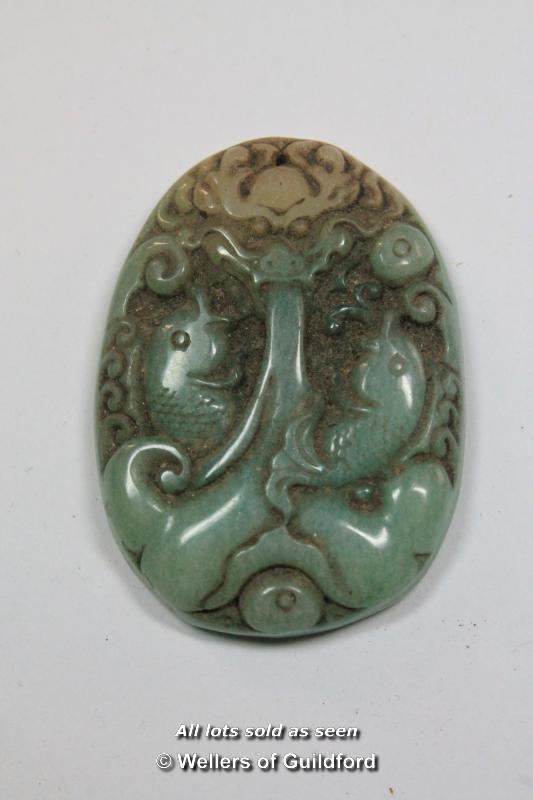 A Chinese hardstone oval pendant carved as a dragon, 5cm.